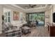 Spacious living room with hardwood floors, a tray ceiling, and sliding doors to the lanai at 11551 Callisia Dr, Odessa, FL 33556