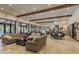 The spacious clubhouse lounge is well-appointed with couches and tables, and features large windows overlooking the pool area at 11551 Callisia Dr, Odessa, FL 33556