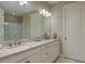 Luxurious bathroom with double sinks, granite countertops, elegant fixtures, and ample cabinet space at 11551 Callisia Dr, Odessa, FL 33556