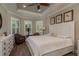 Inviting main bedroom with a tray ceiling, wood floors, bright windows, and comfortable seating area at 11551 Callisia Dr, Odessa, FL 33556