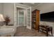 Versatile office offering views into the ensuite bath, with french doors, and warm wood floors at 11551 Callisia Dr, Odessa, FL 33556