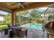 Relaxing screened-in pool area, perfect for entertaining, with comfortable seating and a grill at 11551 Callisia Dr, Odessa, FL 33556