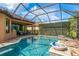 Inviting screened-in pool with custom features in an outdoor living space with lush landscaping at 11551 Callisia Dr, Odessa, FL 33556