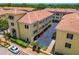 Aerial view of condos showcasing meticulous landscaping, red tile roofs, and spacious parking at 119 Beach Haven Ln, Tampa, FL 33609