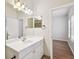 Bright bathroom featuring large mirror with decorative lights and a single sink vanity at 119 Beach Haven Ln, Tampa, FL 33609