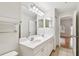 Bright bathroom with double sink vanity, large mirror, and modern lighting at 119 Beach Haven Ln, Tampa, FL 33609