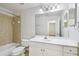 Bathroom featuring a bathtub, toilet, vanity with ample storage, and large mirror at 119 Beach Haven Ln, Tampa, FL 33609