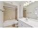Well-lit bathroom featuring a tiled shower/tub, vanity and modern fixtures at 119 Beach Haven Ln, Tampa, FL 33609
