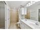 Bright bathroom with double vanity, tiled shower and floors, and ample storage at 119 Beach Haven Ln, Tampa, FL 33609