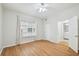 Bright bedroom with hardwood floors, ceiling fan, and an ensuite bathroom entrance at 119 Beach Haven Ln, Tampa, FL 33609