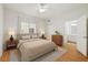 Cozy bedroom featuring a ceiling fan, natural light, and an ensuite bathroom at 119 Beach Haven Ln, Tampa, FL 33609