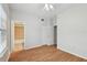 Spacious bedroom featuring laminate flooring, ceiling fan, and access to bathroom at 119 Beach Haven Ln, Tampa, FL 33609