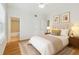 Bedroom featuring modern décor, ensuite bathroom, hardwood floors, and natural lighting at 119 Beach Haven Ln, Tampa, FL 33609