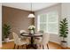 Cozy dining room featuring a modern table set, stylish lighting, and attractive wood accent wall at 119 Beach Haven Ln, Tampa, FL 33609