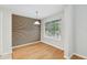 Dining room with hardwood floors, modern lighting, and large window at 119 Beach Haven Ln, Tampa, FL 33609