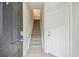 Condo entryway with tiled floors, carpeted stairs, and a view looking up to the next level at 119 Beach Haven Ln, Tampa, FL 33609