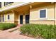 Charming condominium exterior with brick walkway, manicured landscaping, and inviting front entrances with black doors at 119 Beach Haven Ln, Tampa, FL 33609