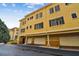 Three-story condo with private garages and black shuttered windows providing modern amenities and curb appeal at 119 Beach Haven Ln, Tampa, FL 33609