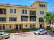 Beautiful multi-story condo building featuring a red tile roof, shutters, and meticulous landscaping at 119 Beach Haven Ln, Tampa, FL 33609