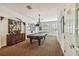 Community game room with a classic pool table, vintage lighting, and neutral decor at 119 Beach Haven Ln, Tampa, FL 33609