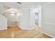 Hallway with hardwood floors, white trim, and views into an adjacent room at 119 Beach Haven Ln, Tampa, FL 33609