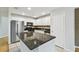 Kitchen with stainless steel appliances, stone countertops, white cabinets, and tiled floors at 119 Beach Haven Ln, Tampa, FL 33609