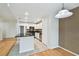 Kitchen and dining room featuring stone counters, stainless steel appliances, and wood floors at 119 Beach Haven Ln, Tampa, FL 33609