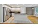 Kitchen with stainless steel appliances, stone countertops, white cabinets, and tiled floors at 119 Beach Haven Ln, Tampa, FL 33609