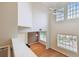 View of the light-filled living room with vaulted ceilings and beautiful wood floors at 119 Beach Haven Ln, Tampa, FL 33609