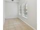 Empty room with natural light through large windows, tiled floors, and neutral paint creates a bright space at 119 Beach Haven Ln, Tampa, FL 33609