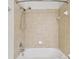 Beige tiled shower with handheld shower head, soap dish, and shower rod at 119 Beach Haven Ln, Tampa, FL 33609