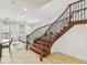 Elegant wooden staircase with decorative iron railing in a naturally lit living area at 119 Beach Haven Ln, Tampa, FL 33609