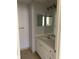 Bathroom vanity with large mirror and white cabinetry at 125 Grand Beach Pl # 125, Tampa, FL 33609