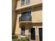 Two-story condo featuring a balcony with seating and black doors at 125 Grand Beach Pl # 125, Tampa, FL 33609