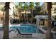 Community swimming pool with several lounge chairs at 125 Grand Beach Pl # 125, Tampa, FL 33609