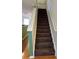 Carpeted stairs with white railing, leading to the second floor at 125 Grand Beach Pl # 125, Tampa, FL 33609