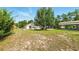 Large backyard with ample space, a screened pool, and a covered area for storage at 15348 Glossy Ibis Rd, Weeki Wachee, FL 34614