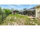 Spacious backyard with screened pool and additional covered storage area at 15348 Glossy Ibis Rd, Weeki Wachee, FL 34614
