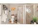 Bathroom featuring glass shower, toilet, and decorative shelving at 15348 Glossy Ibis Rd, Weeki Wachee, FL 34614
