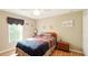 Cozy bedroom with a ceiling fan, bedside table, and decorative touches at 15348 Glossy Ibis Rd, Weeki Wachee, FL 34614