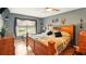 Charming bedroom with wood accents, a ceiling fan, and a large window at 15348 Glossy Ibis Rd, Weeki Wachee, FL 34614