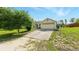 Well-maintained home with an attached two-car garage and concrete driveway at 15348 Glossy Ibis Rd, Weeki Wachee, FL 34614