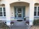 Inviting front entryway with a decorated door and potted plants at 15348 Glossy Ibis Rd, Weeki Wachee, FL 34614
