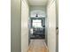 A lovely hallway with tile floors leads to a bedroom with a bear-themed motif and an arched doorway at 15348 Glossy Ibis Rd, Weeki Wachee, FL 34614