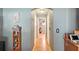 Hallway with tile flooring, storage shelves, and neutral paint at 15348 Glossy Ibis Rd, Weeki Wachee, FL 34614