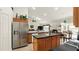 Modern kitchen with stainless steel appliances, granite countertops, and a center island at 15348 Glossy Ibis Rd, Weeki Wachee, FL 34614