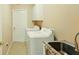 Functional laundry area with washer, dryer, and utility sink for convenience at 15348 Glossy Ibis Rd, Weeki Wachee, FL 34614