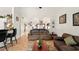 Open-concept living room features hardwood floors, neutral paint, and comfortable furniture at 15348 Glossy Ibis Rd, Weeki Wachee, FL 34614