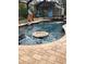 A luxurious screened pool featuring a floating table for endless fun at 15348 Glossy Ibis Rd, Weeki Wachee, FL 34614