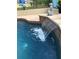 Close up of tranquil waterfall feature enhancing this beautiful pool at 15348 Glossy Ibis Rd, Weeki Wachee, FL 34614